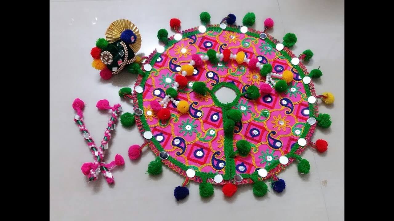 A pink and green decorative item with beads and beads
