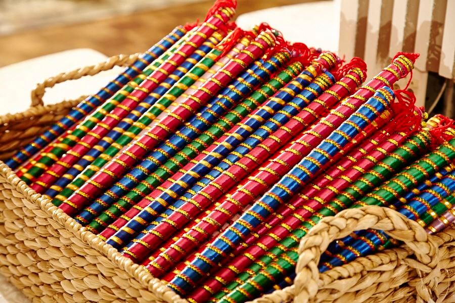 A basket filled with lots of colorful beads
