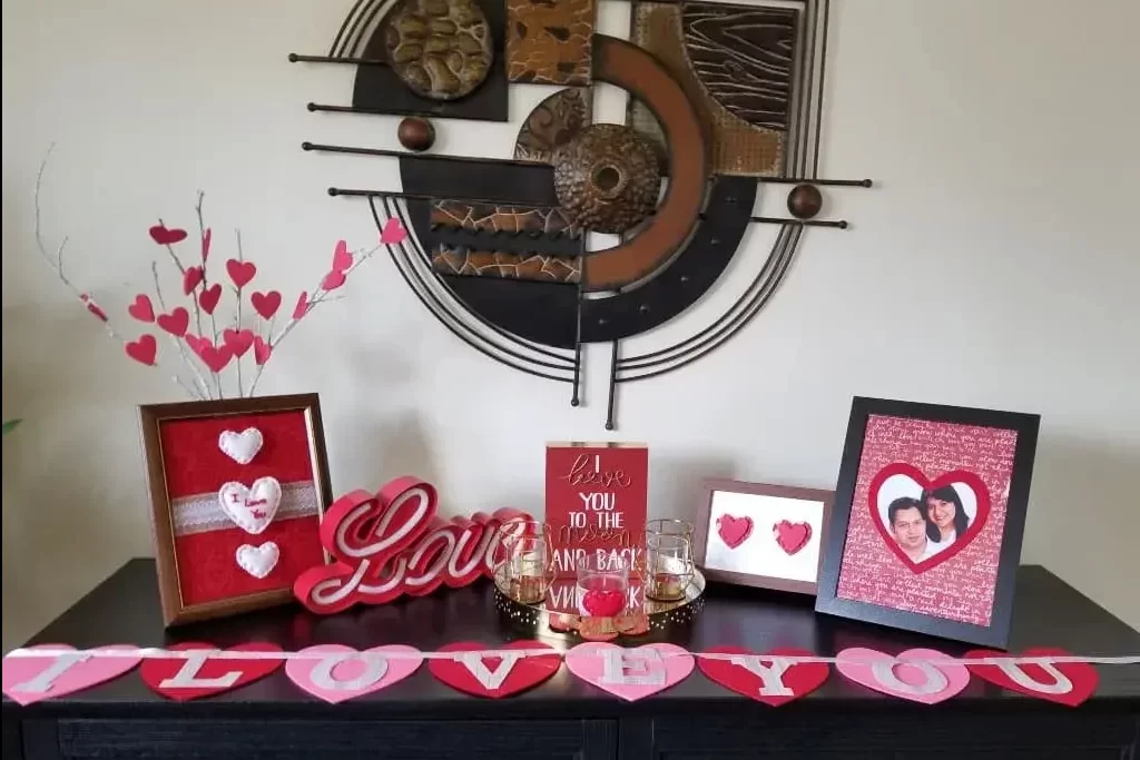 A table topped with cards and pictures next to a clock
