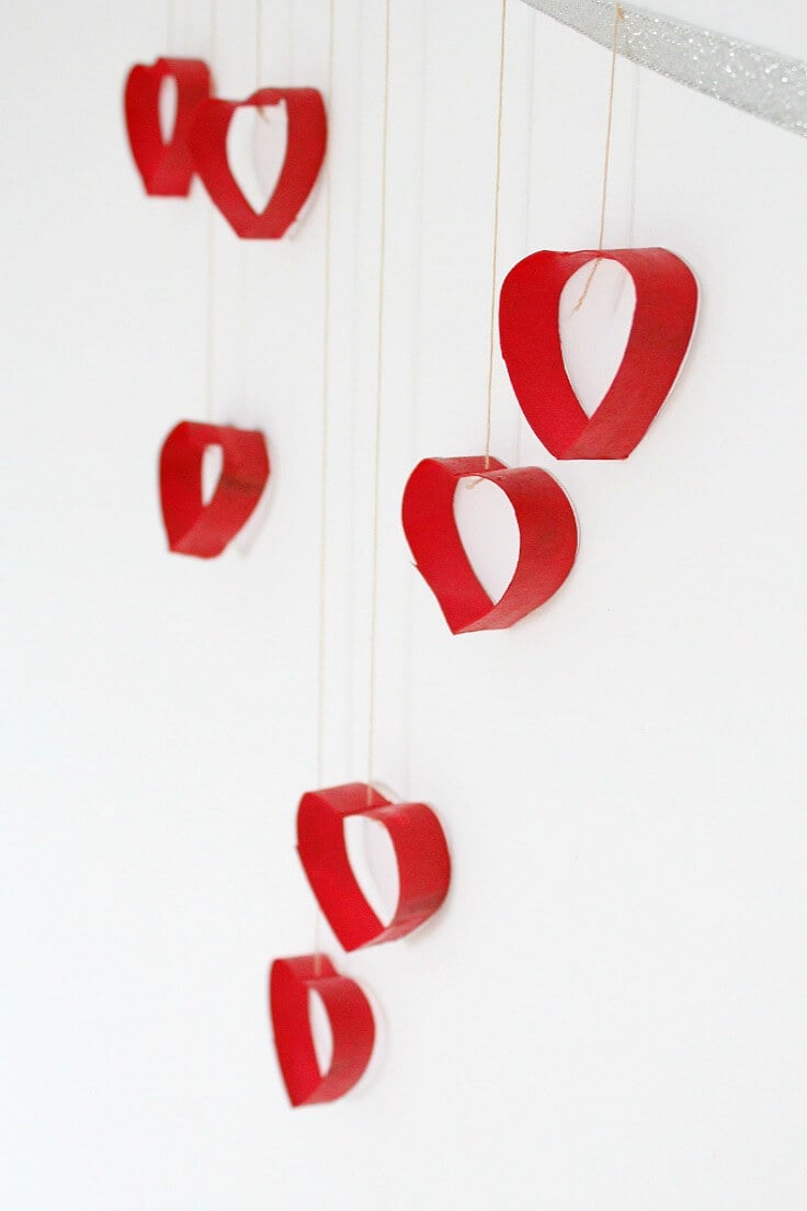 A group of red hearts hanging from a string
