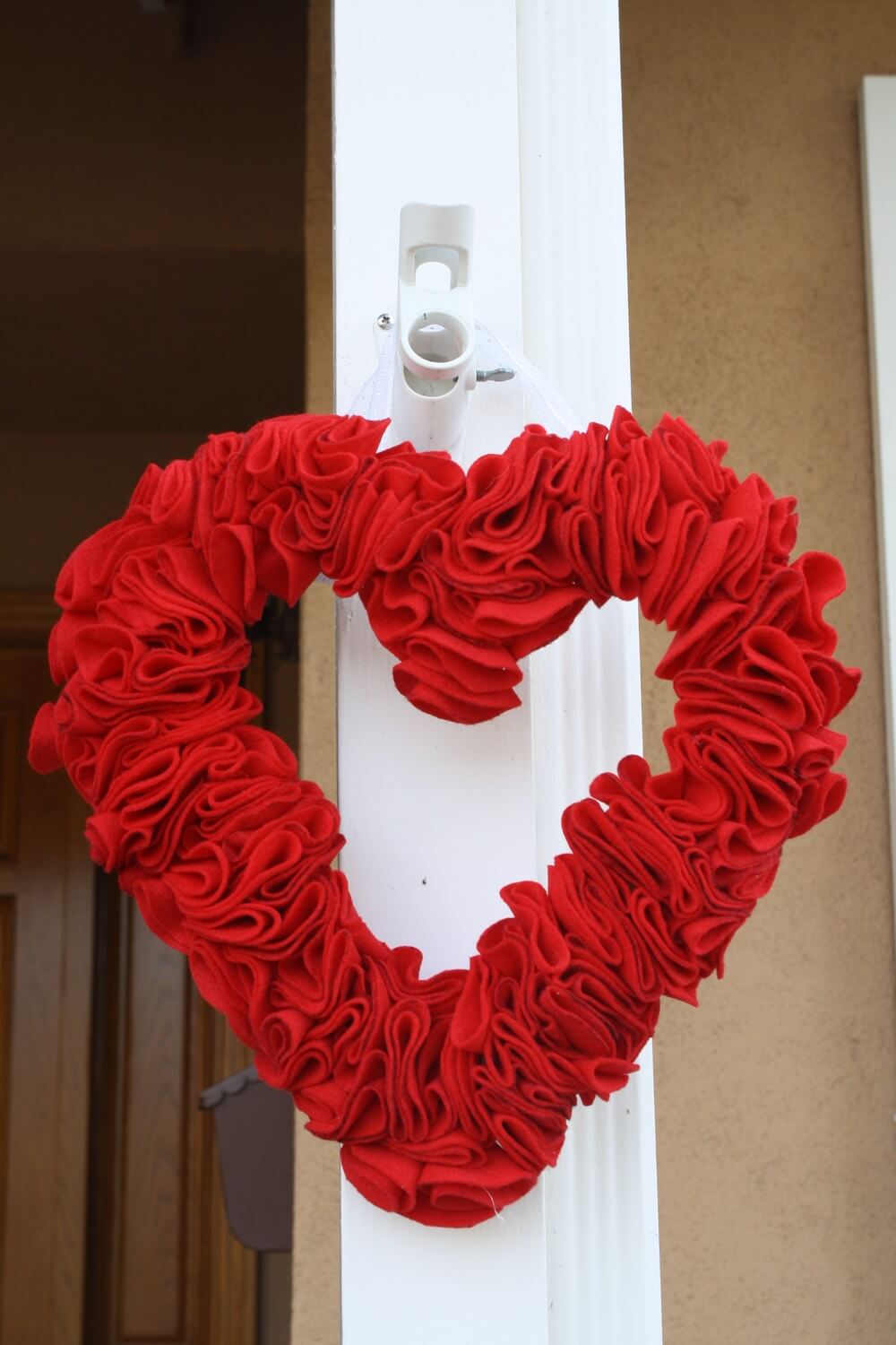 A heart shaped wreath hanging on a door
