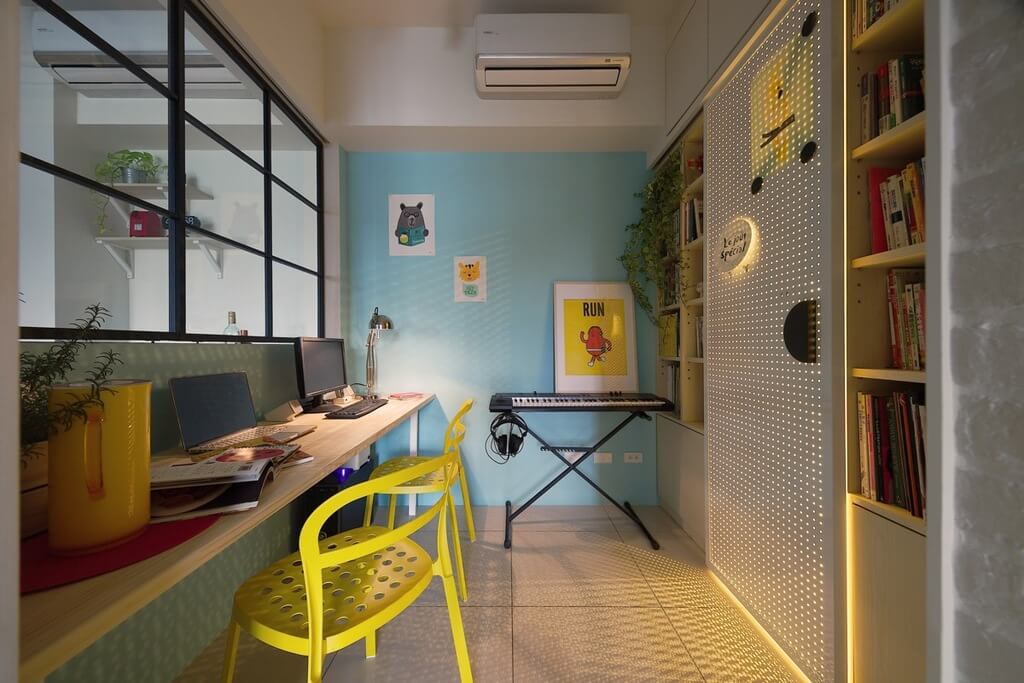 A room with yellow chairs and a blue wall
