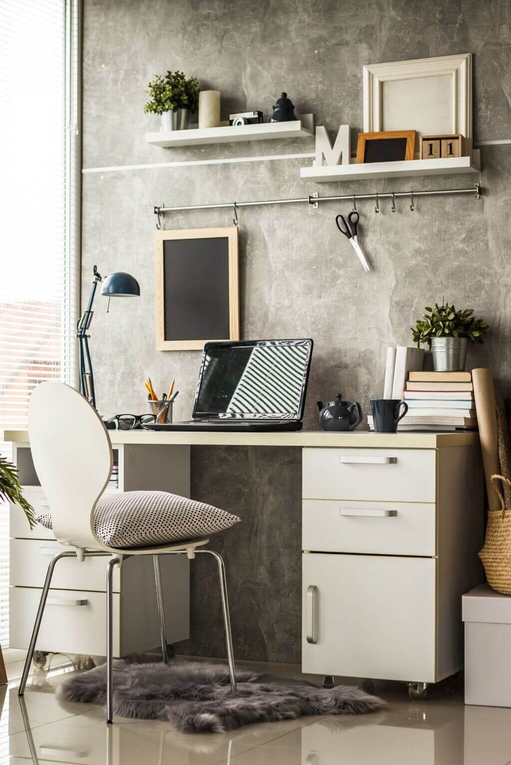 A desk with a laptop on top of it
