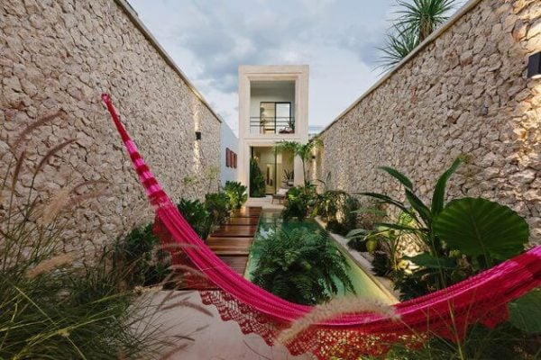 Casa Picasso : A pink hammock hanging from the side of a building
