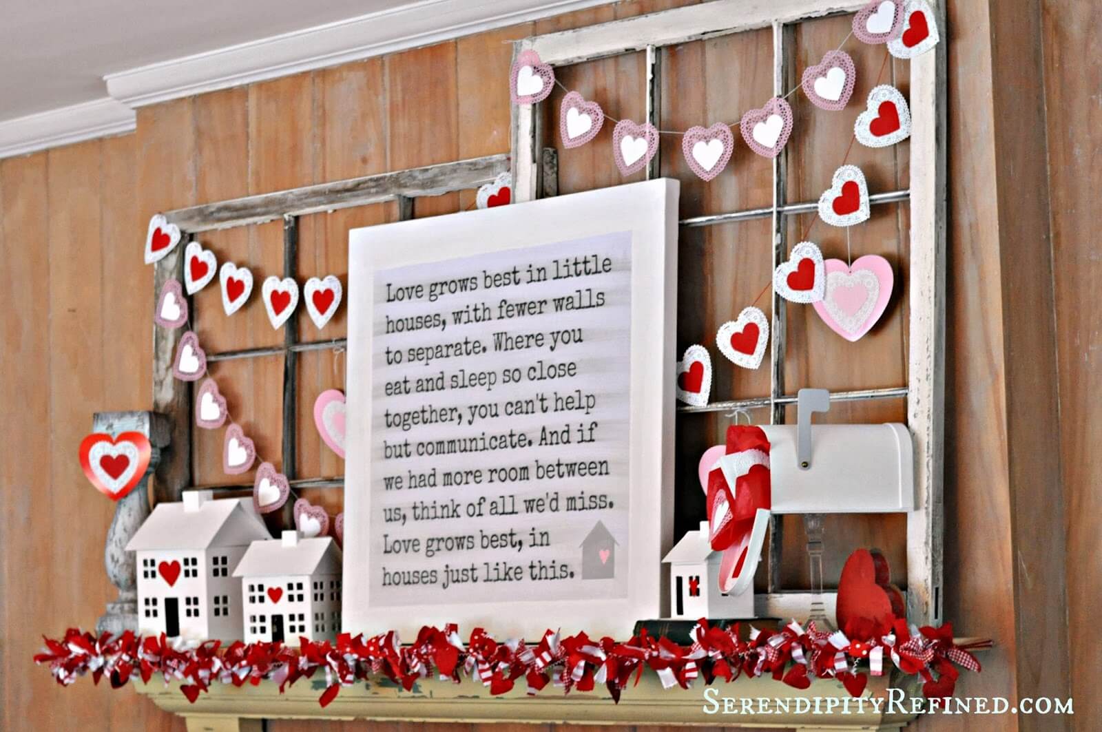 A valentine's day mantel decorated with paper hearts
