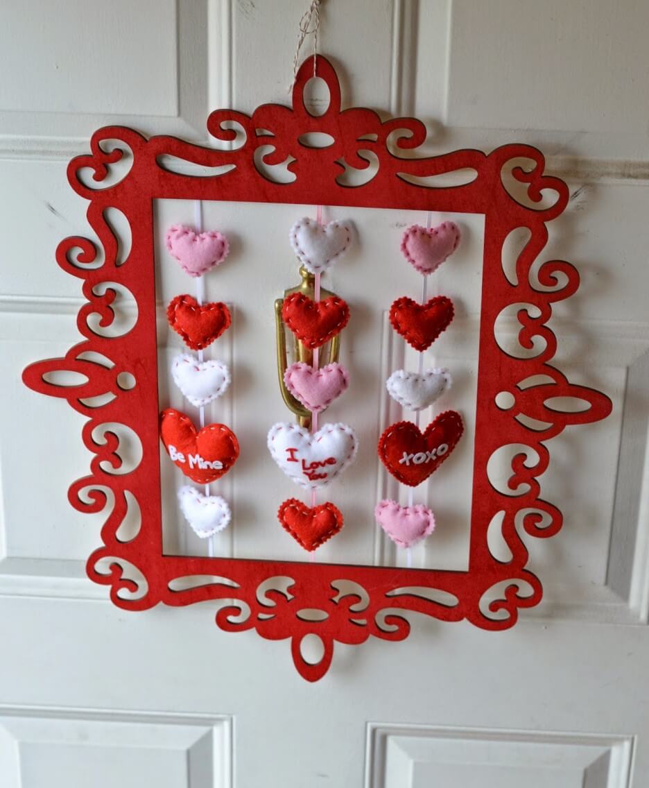A red frame with hearts hanging from it
