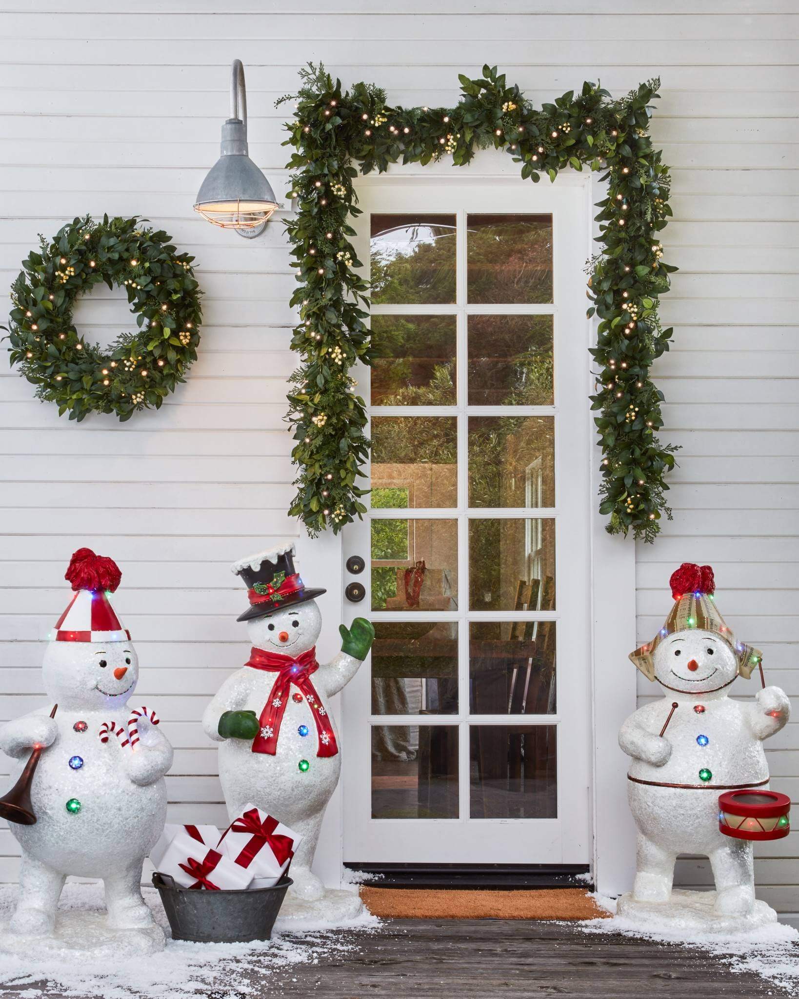 A group of snowmen standing in front of a door
