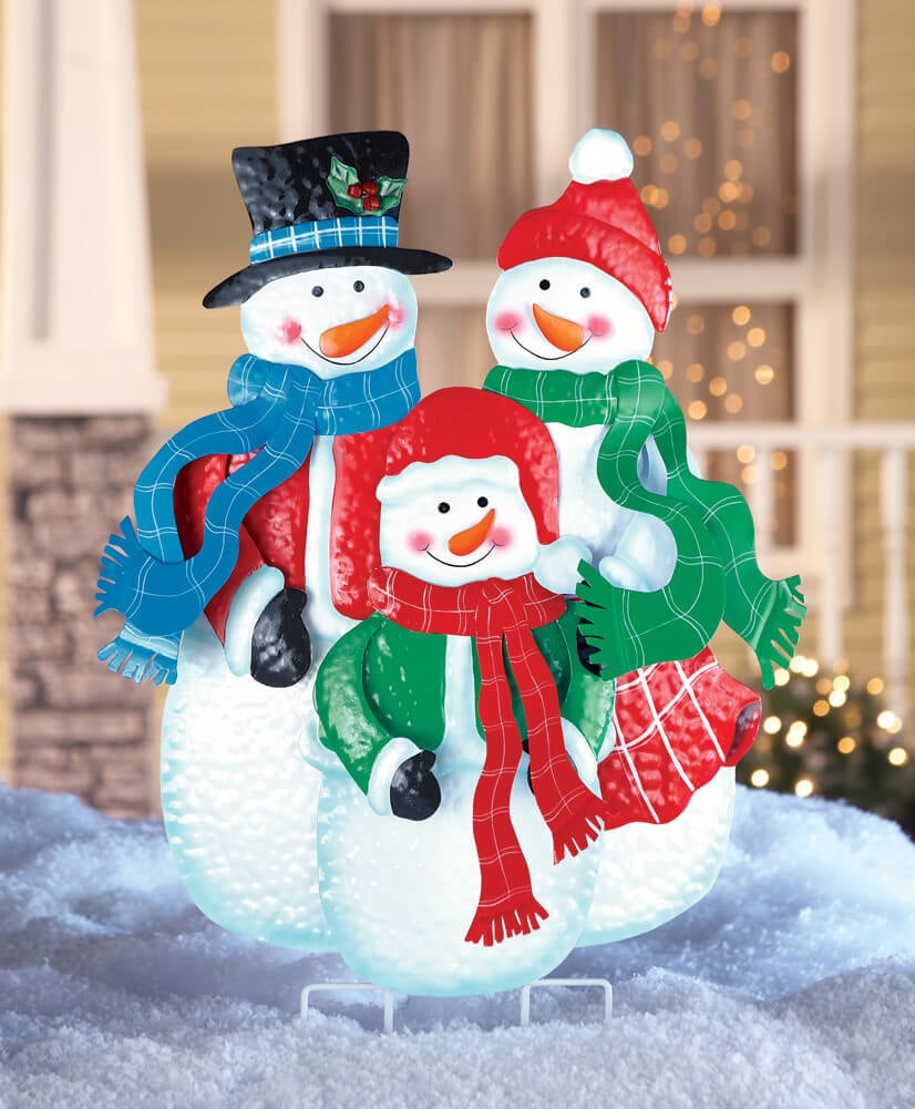 A group of snowmen sitting on top of a pile of snow
