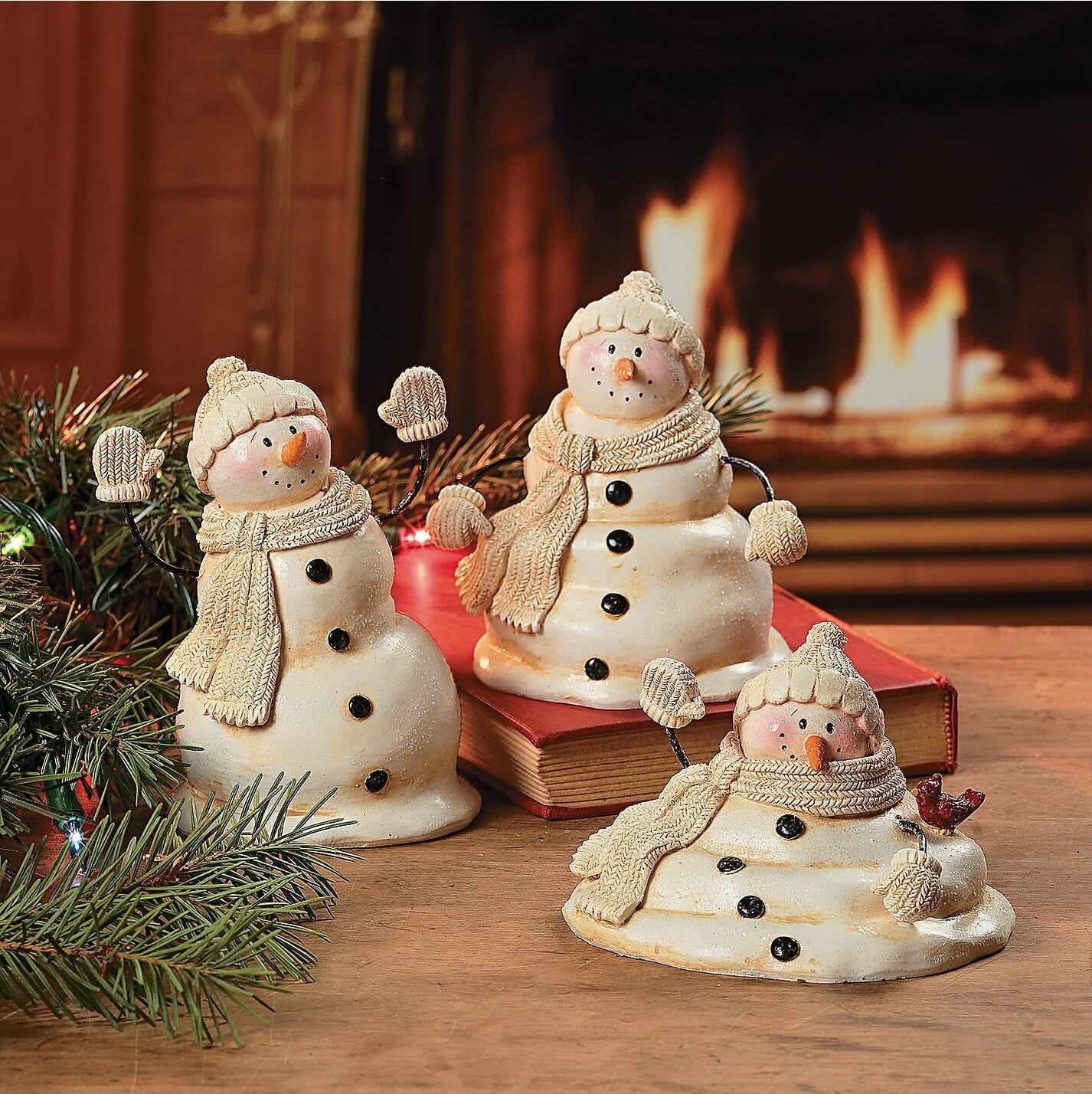 A couple of snowmen sitting on top of a book
