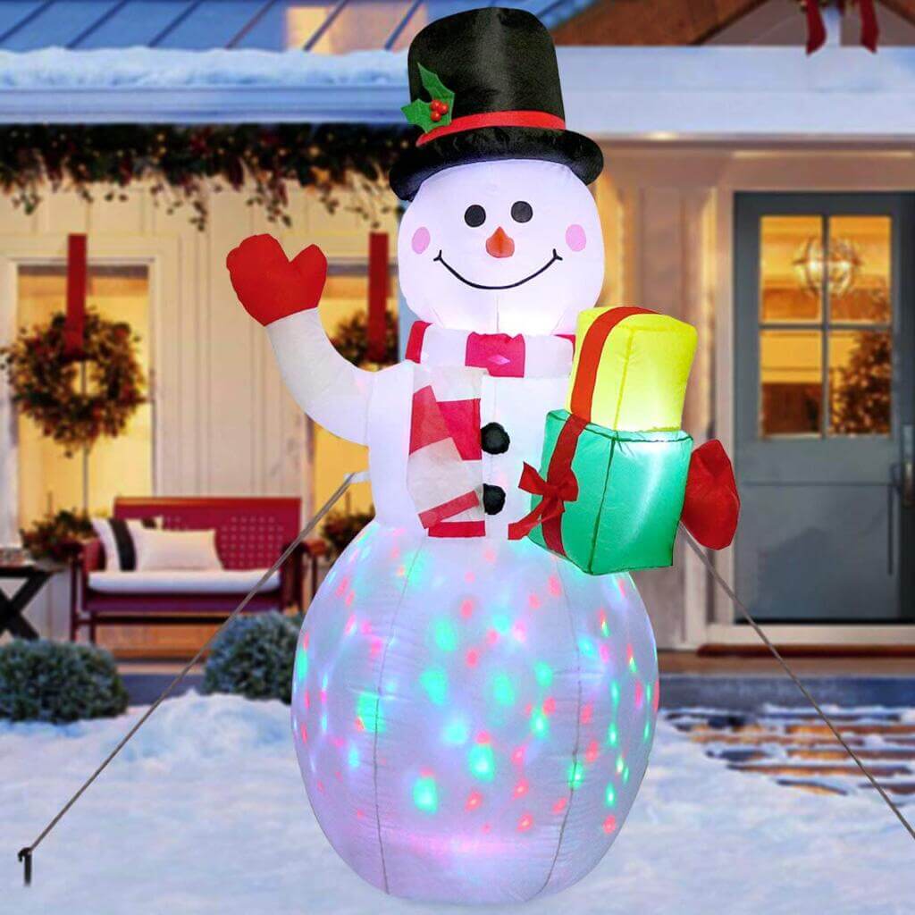 A snowman with a gift in his hand
