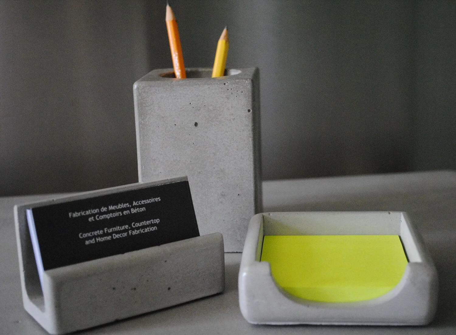A desk with a pen holder and a business card holder
