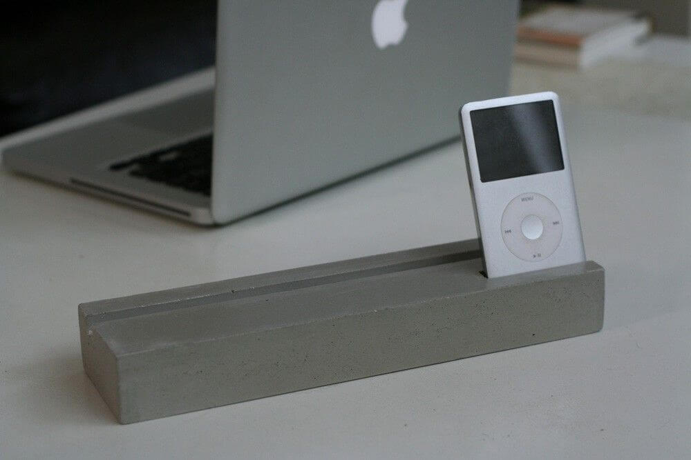 An ipod and a laptop on a table
