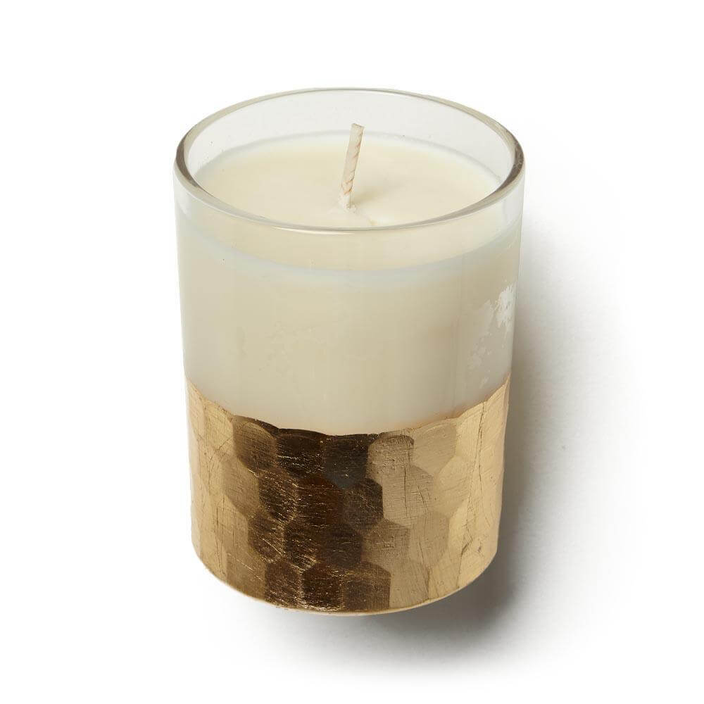 A white candle with a gold rim and a white candle holder
