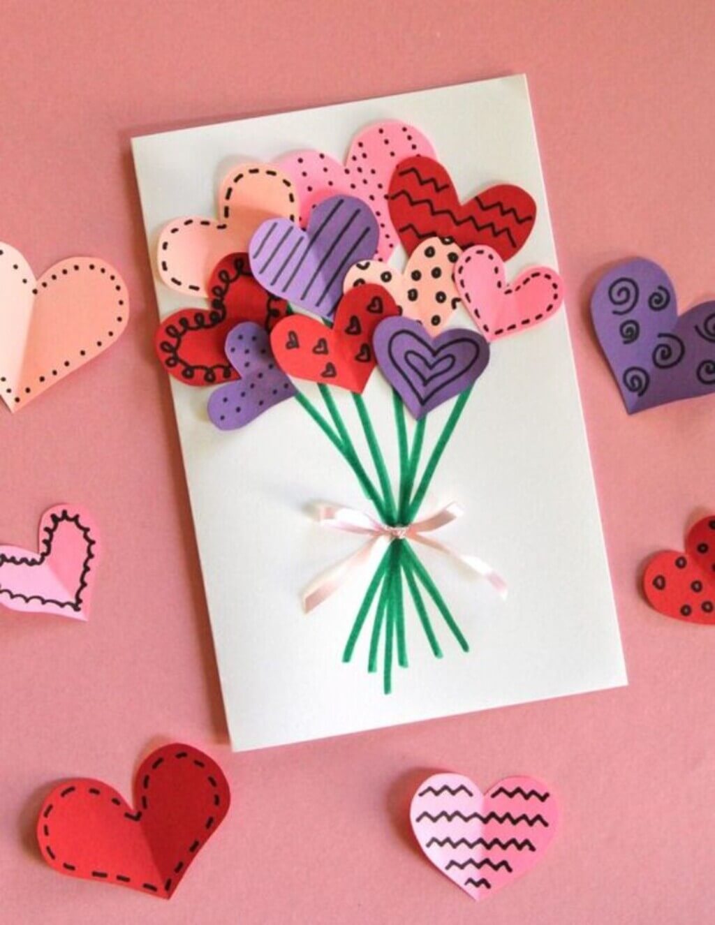A card with hearts and a bouquet of flowers
