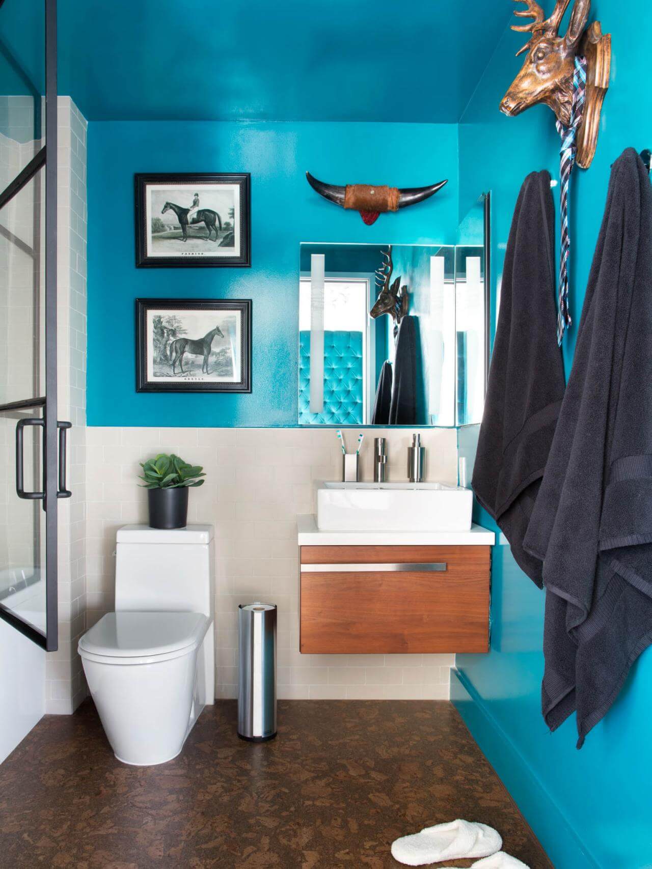 A bathroom with a blue wall and a white toilet
