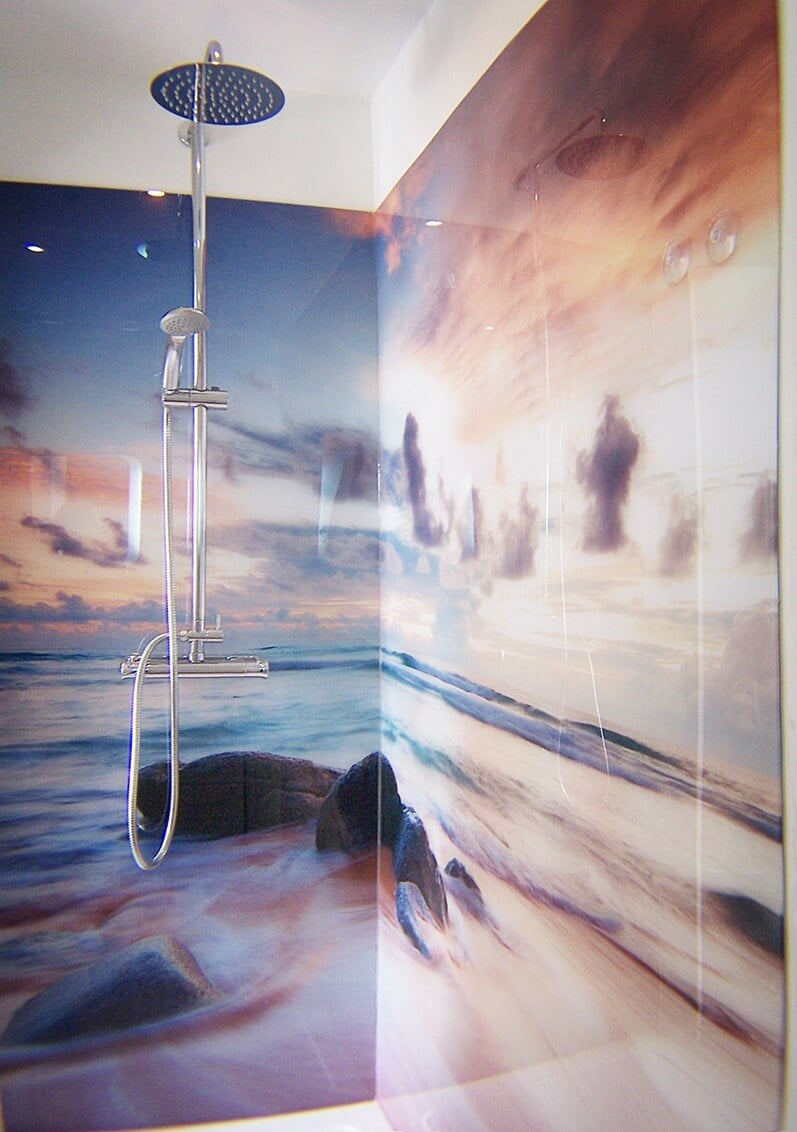 A bathroom with a painting on the wall and a shower head
