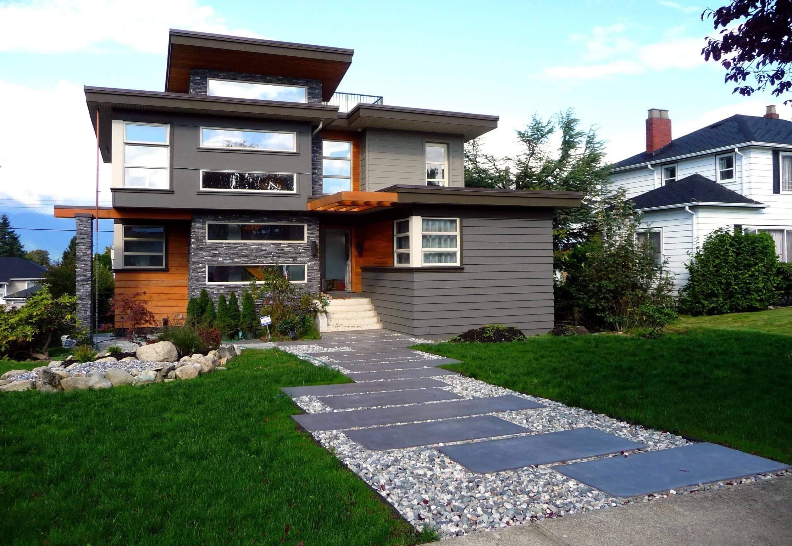 A house with a walkway leading to the front door
