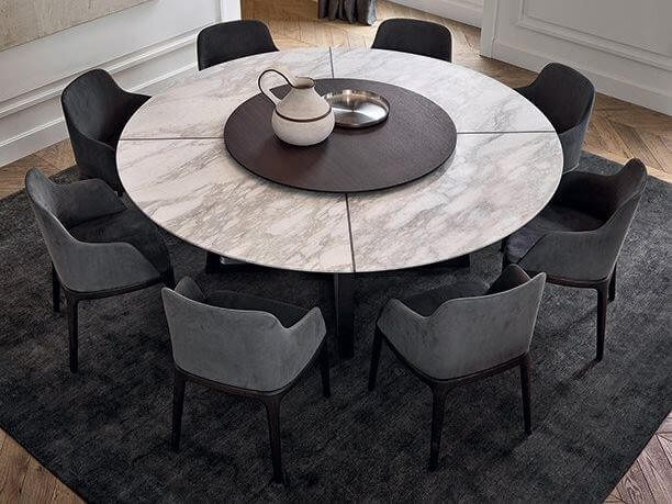 A round dining table with chairs around it
