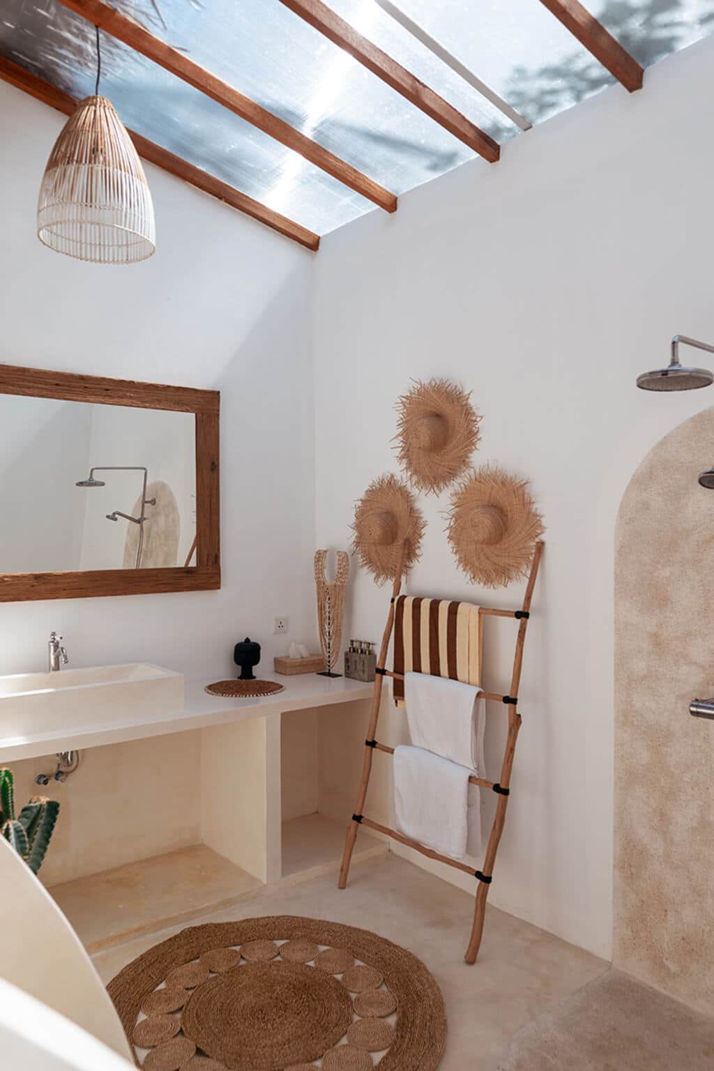 A bathroom with a ladder, sink and mirror
