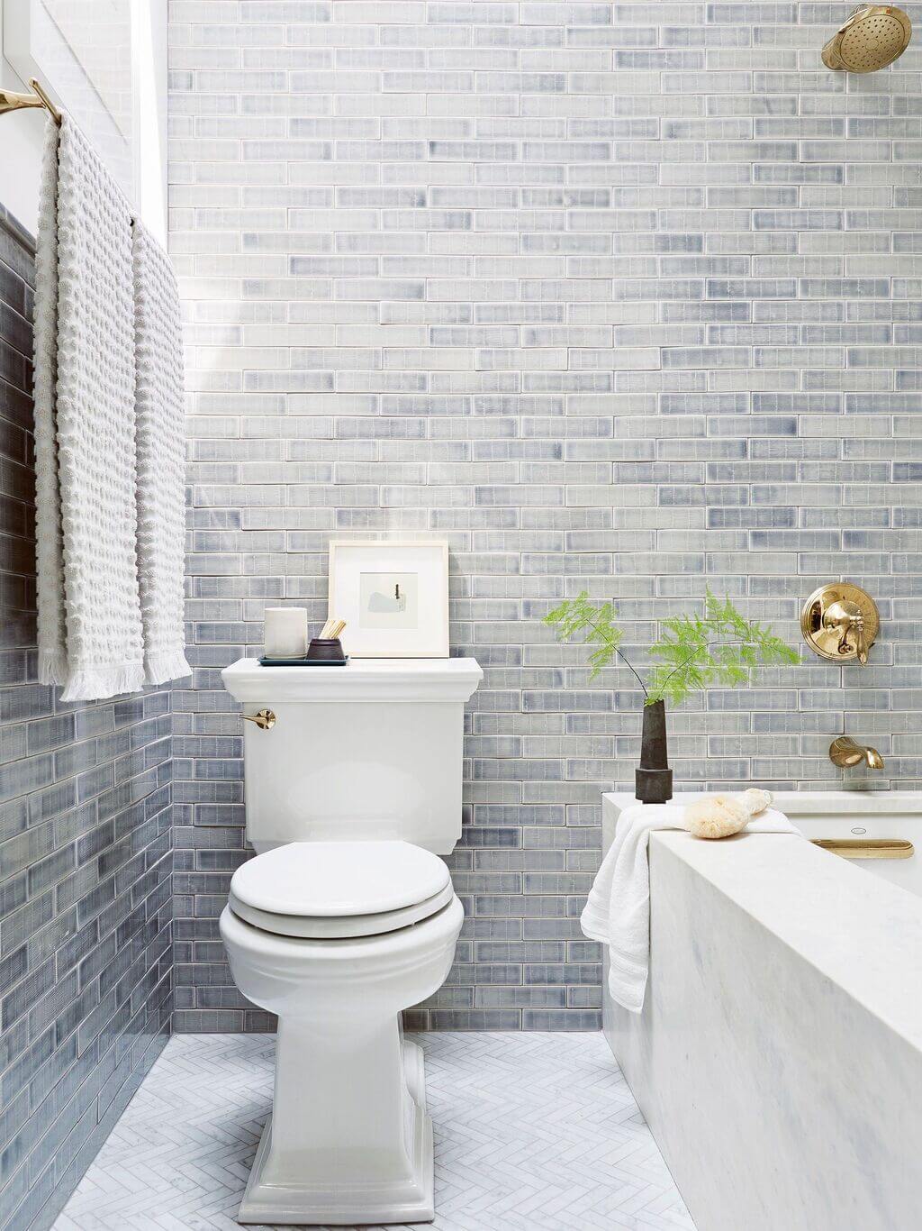 A white toilet sitting in a bathroom next to a bath tub
