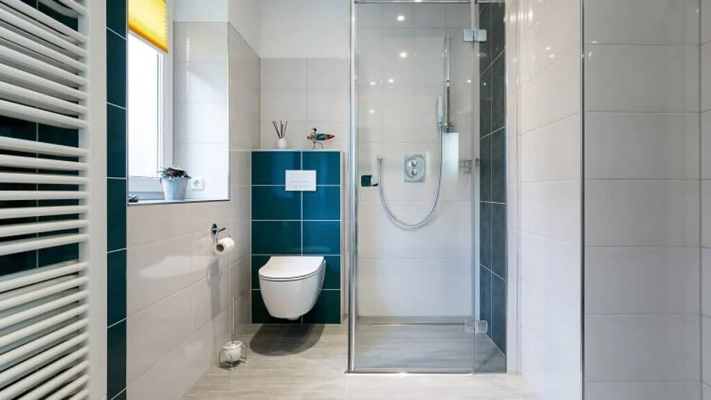 A bathroom with a shower, toilet and sink
