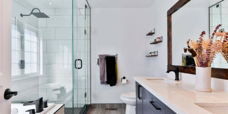 A bathroom with a Transparent Glass Partition and shower
