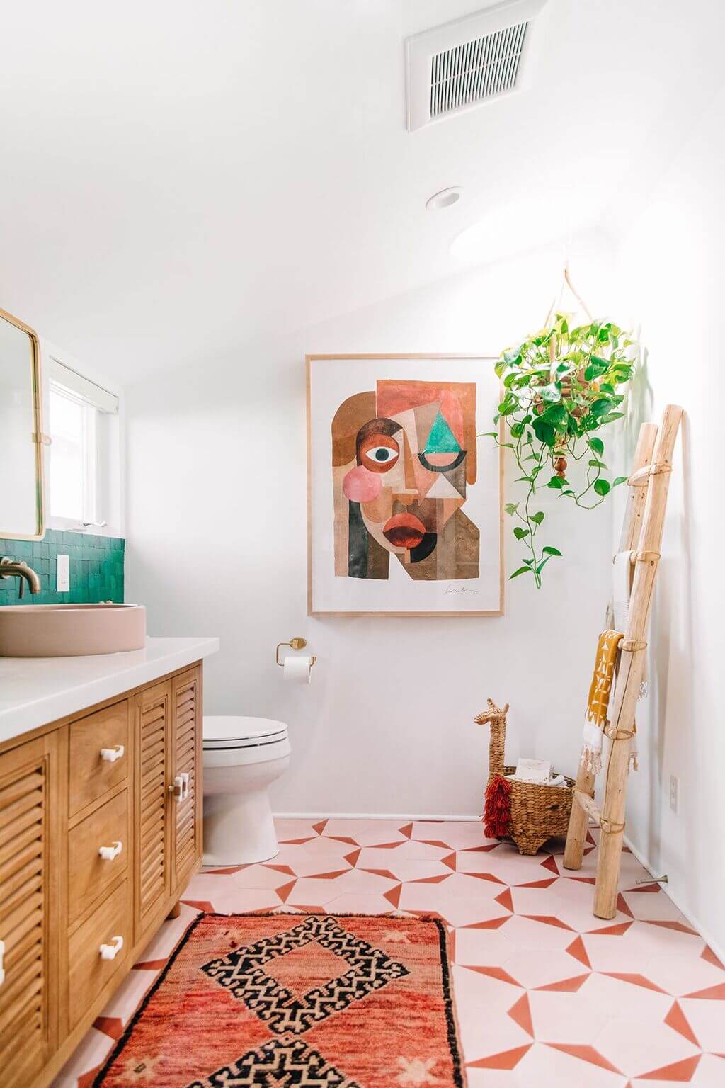 A bathroom with a painting on the wall and a rug on the floor
