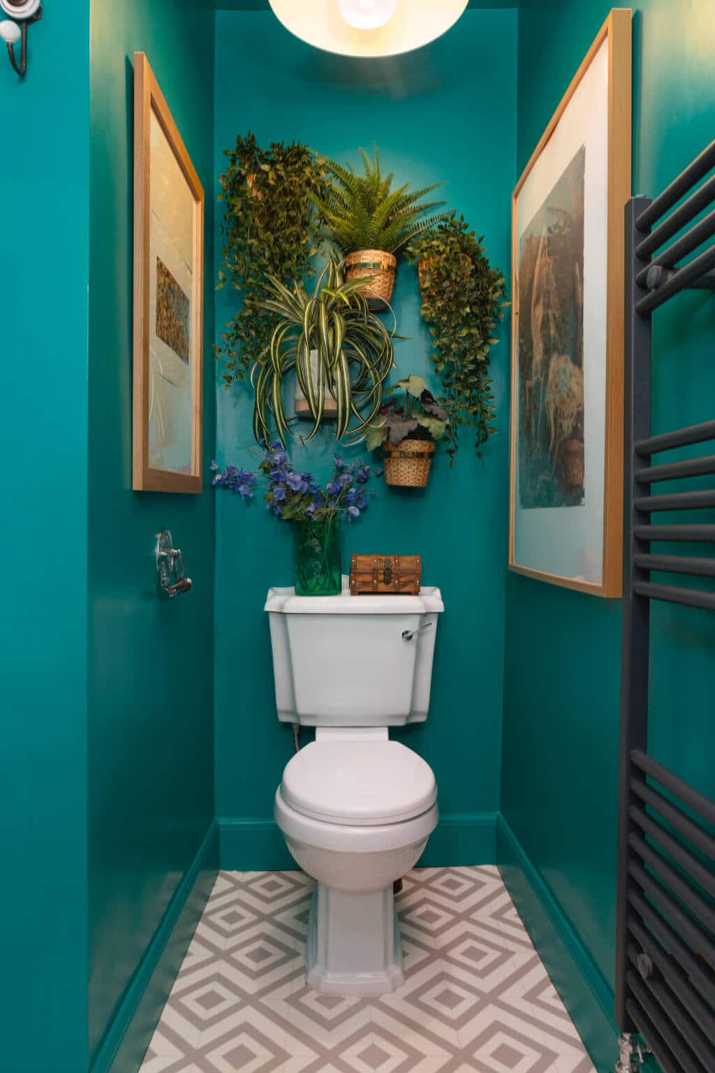 A white toilet sitting in a bathroom next to a green wall
