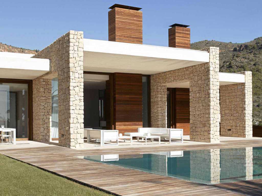 A modern house with a pool and patio
