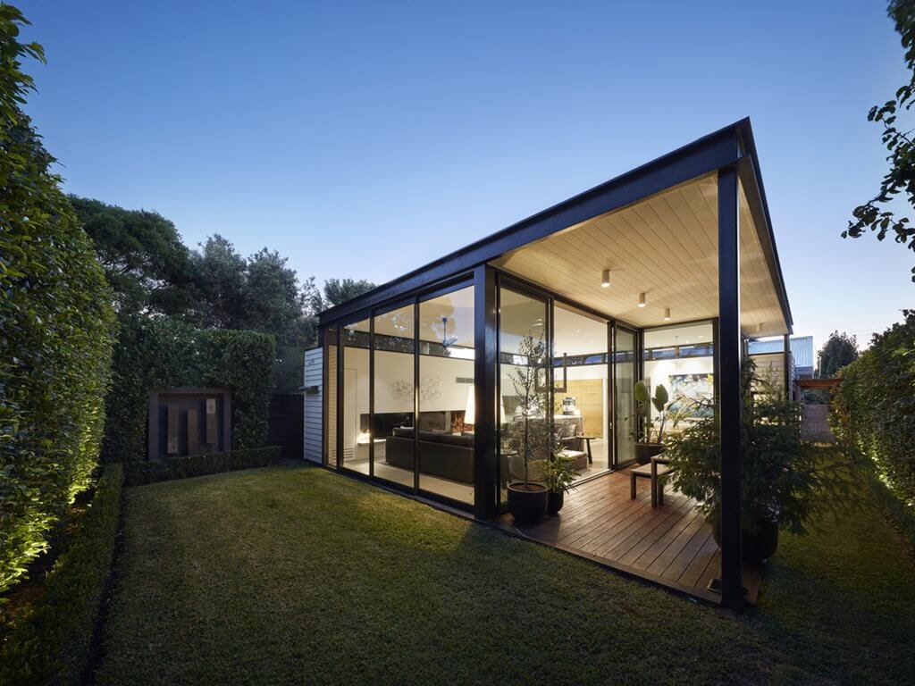 A modern house with a large glass wall
