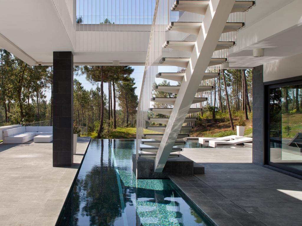 A modern house with a pool and stairs
