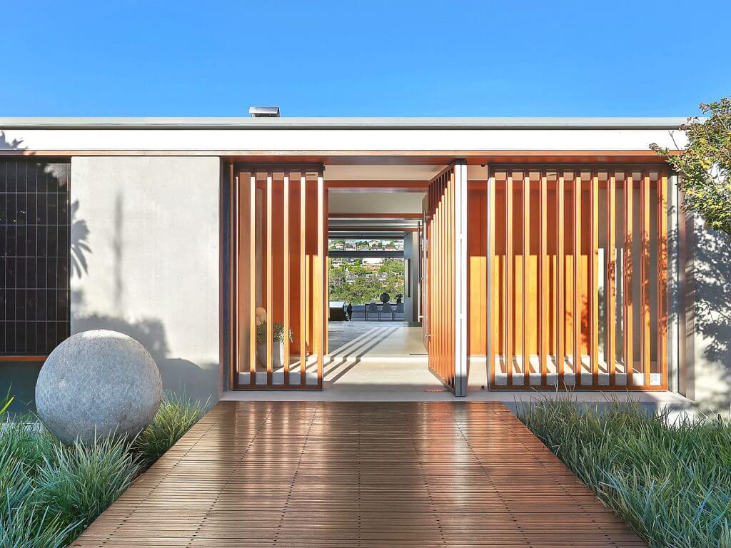 The entrance to a modern home with wooden slats
