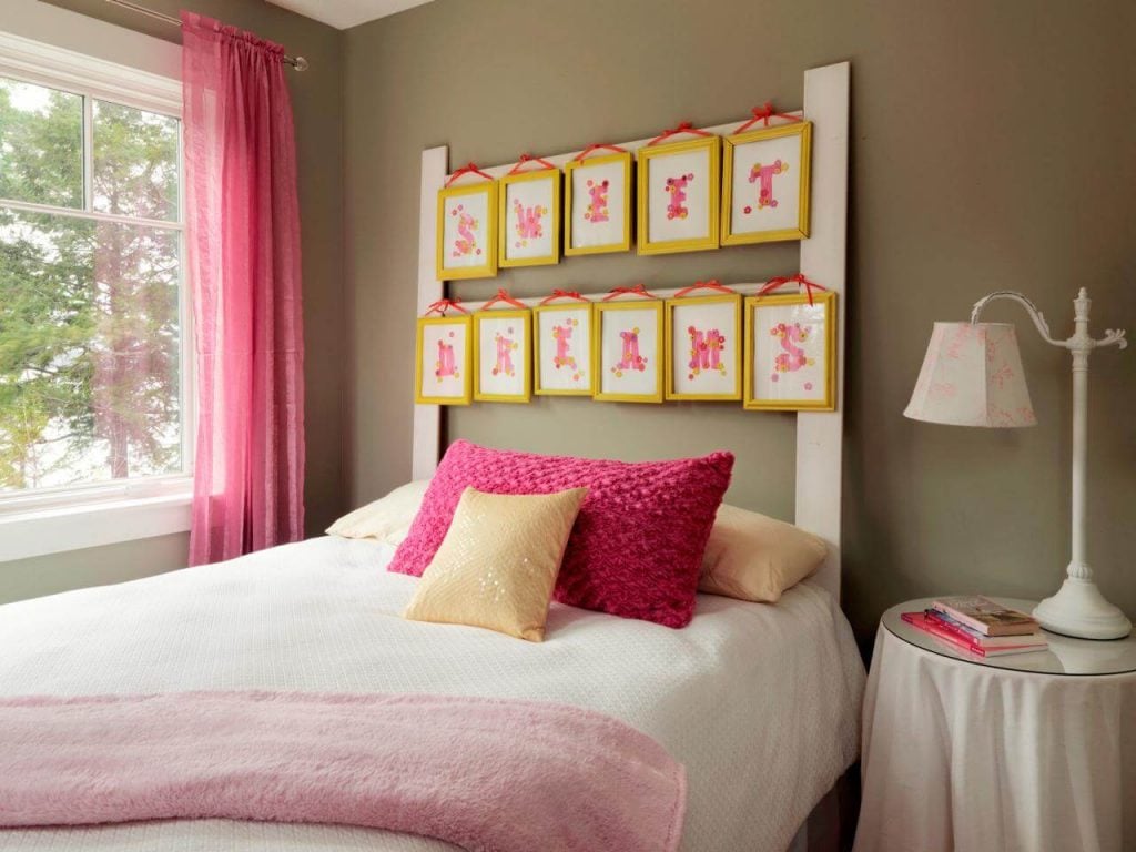 A bedroom with pink and yellow decor and a white bed
