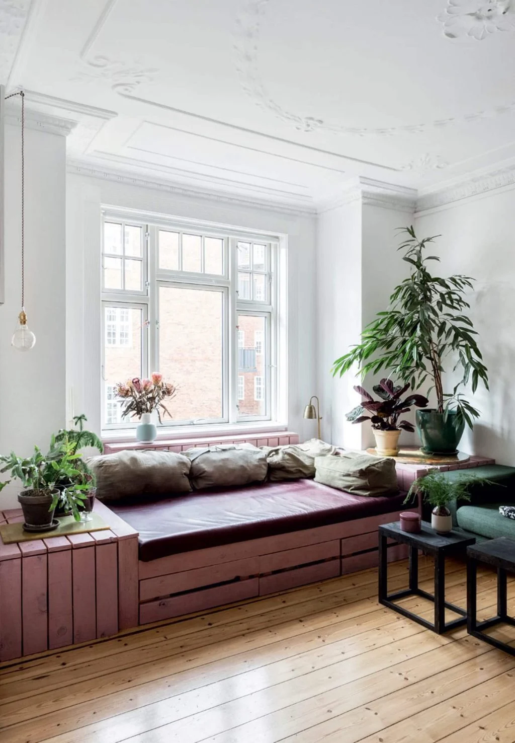 A living room filled with lots of furniture and plants
