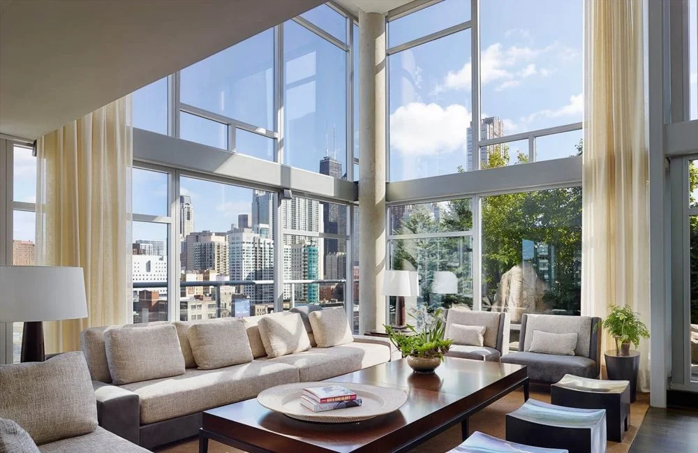 A living room with large windows overlooking the city.