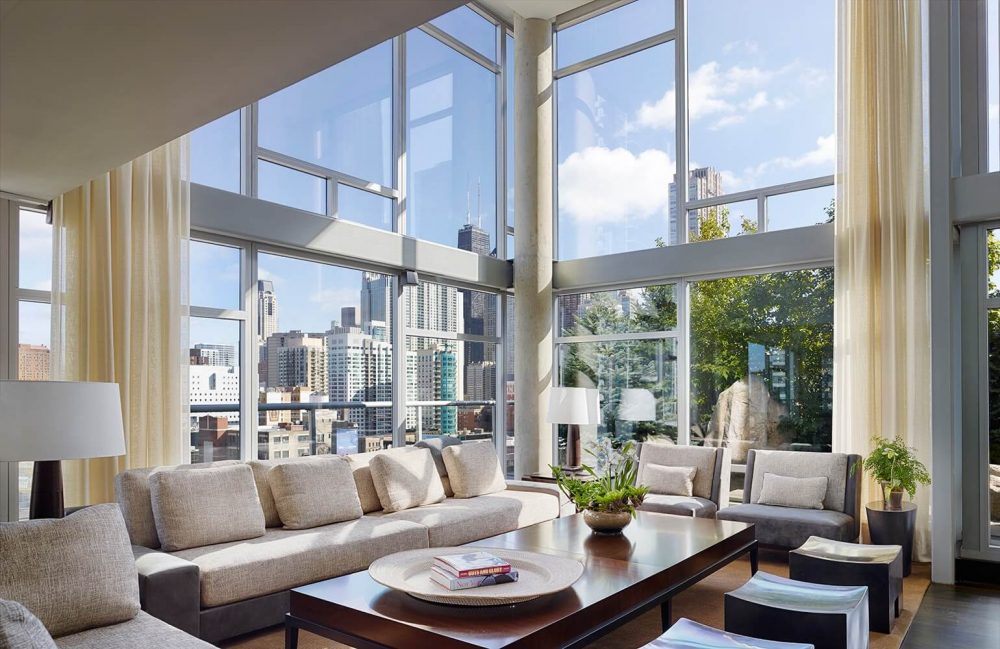 A living room with large windows overlooking the city.