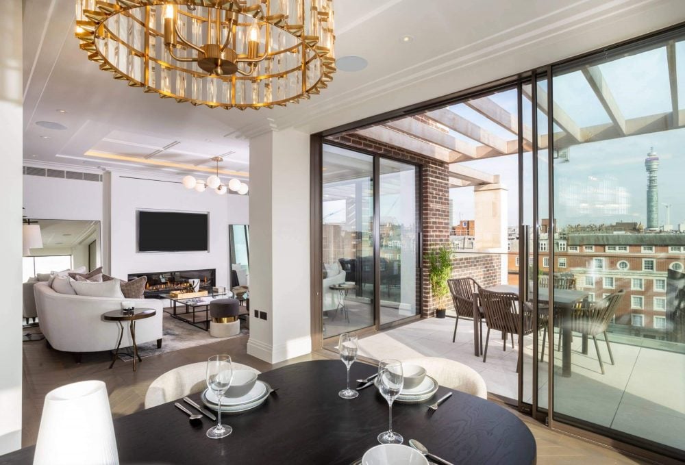 A living room with a balcony overlooking the city.