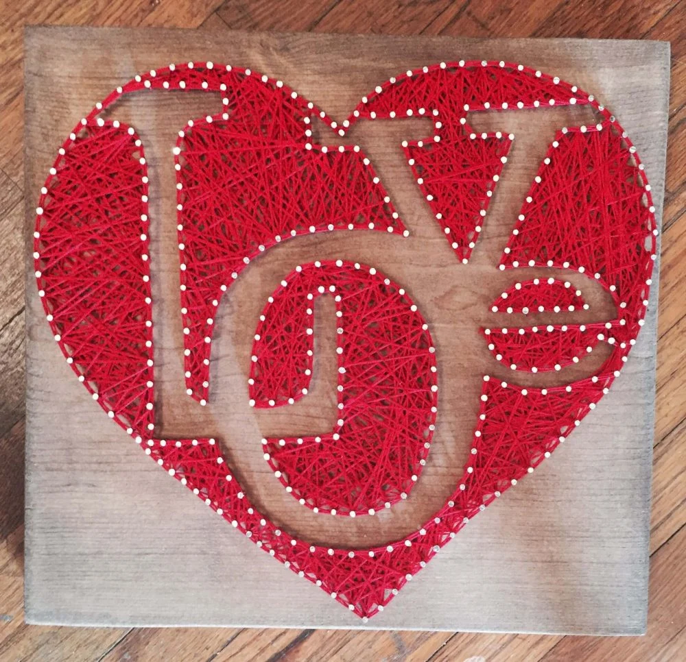 A red heart with the word joy on it
