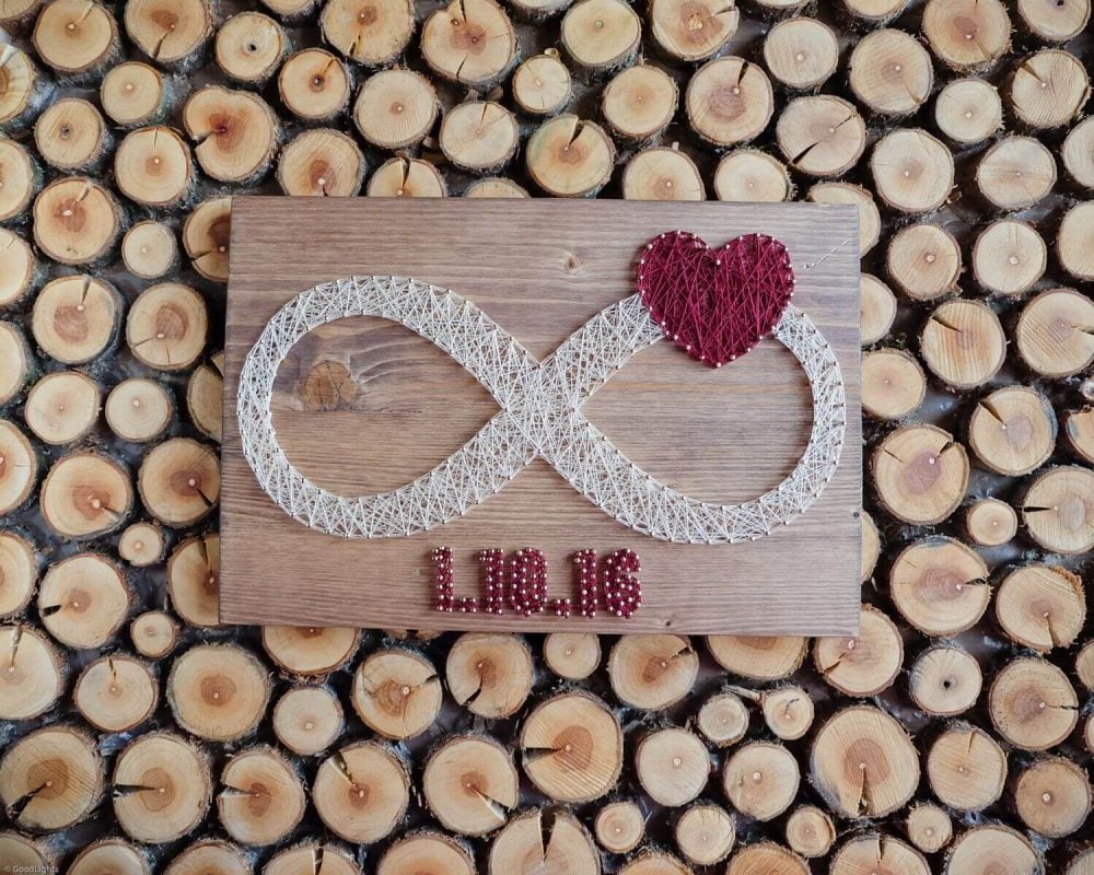 A wooden sign with two hearts on it
