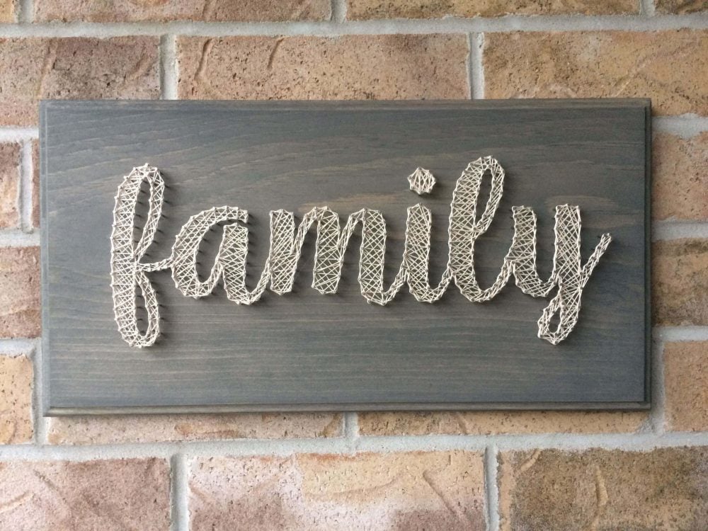 A wooden sign that says family on it
