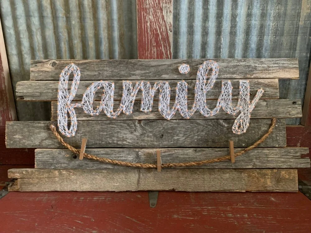 A wooden sign that says, family on it
