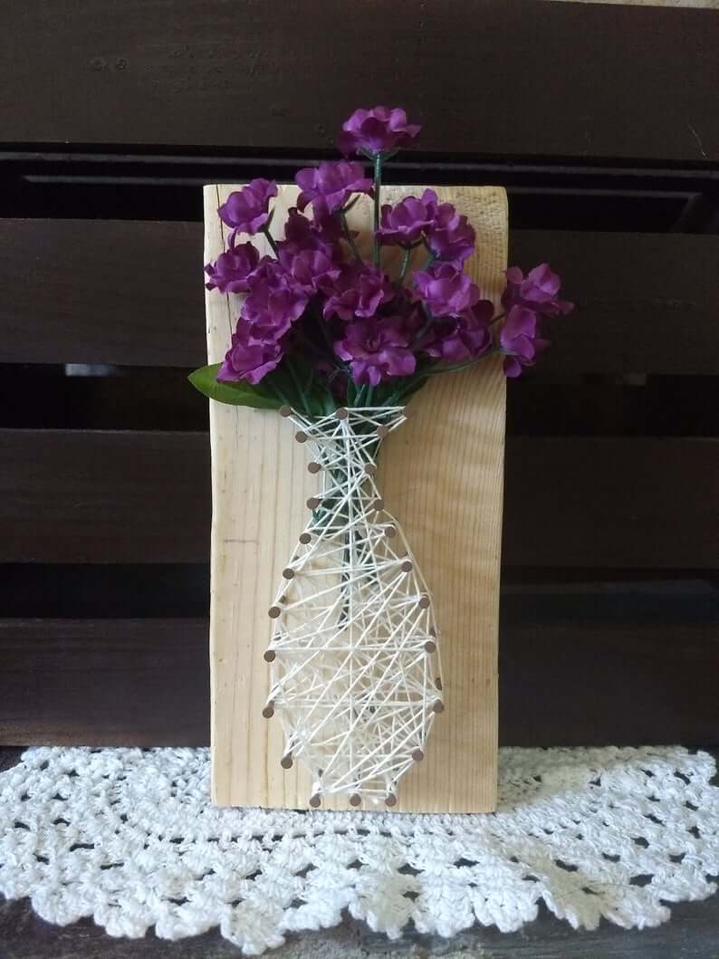 A vase filled with purple flowers sitting on top of a table

