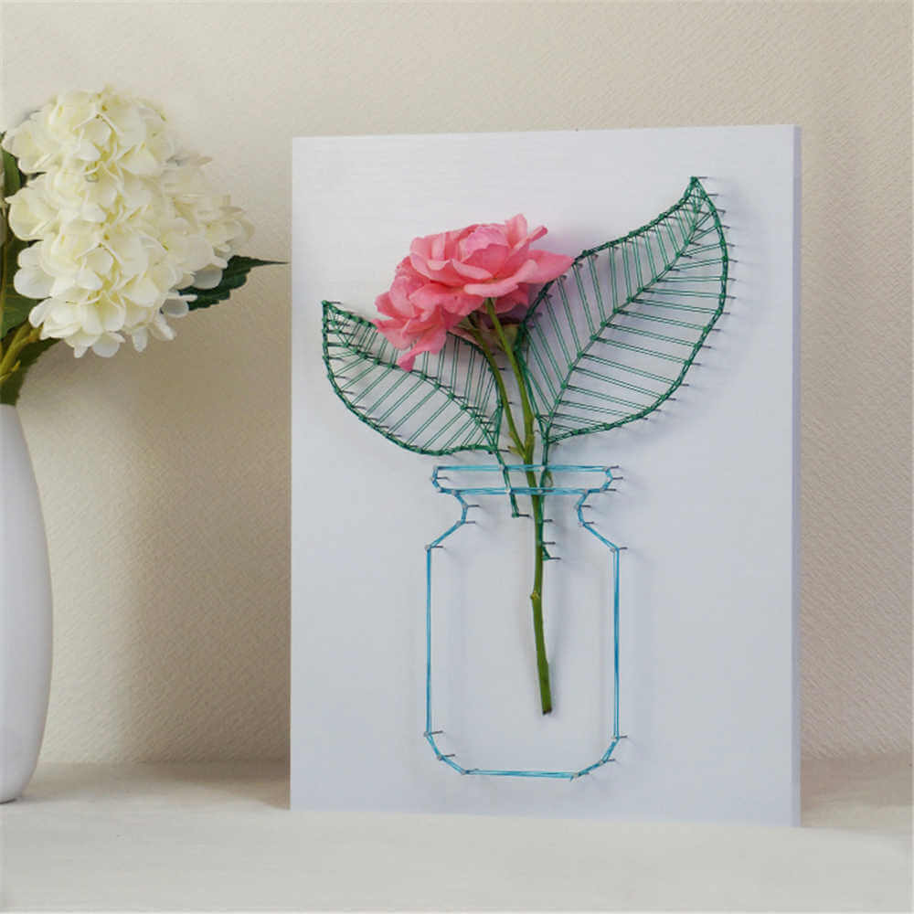 A card with a pink flower in a mason jar
