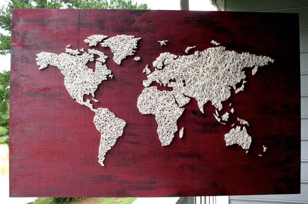 A wooden sign with a map of the world on it
