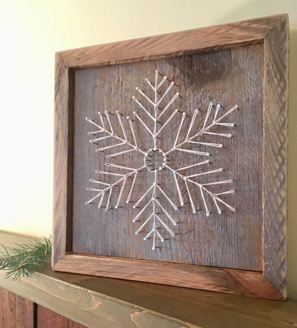 A wooden frame with a snowflake on it
