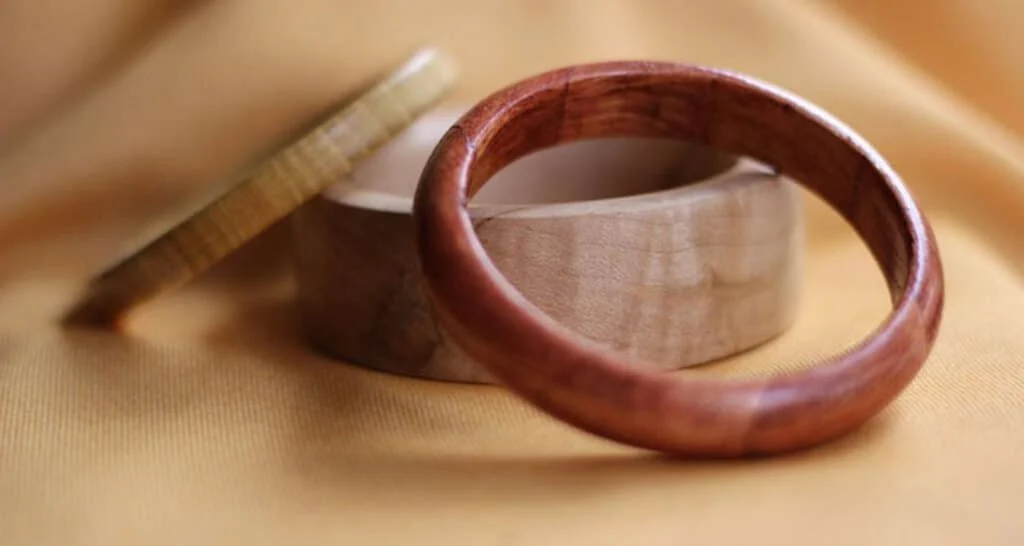 A close up of a wooden bangles on a cloth
