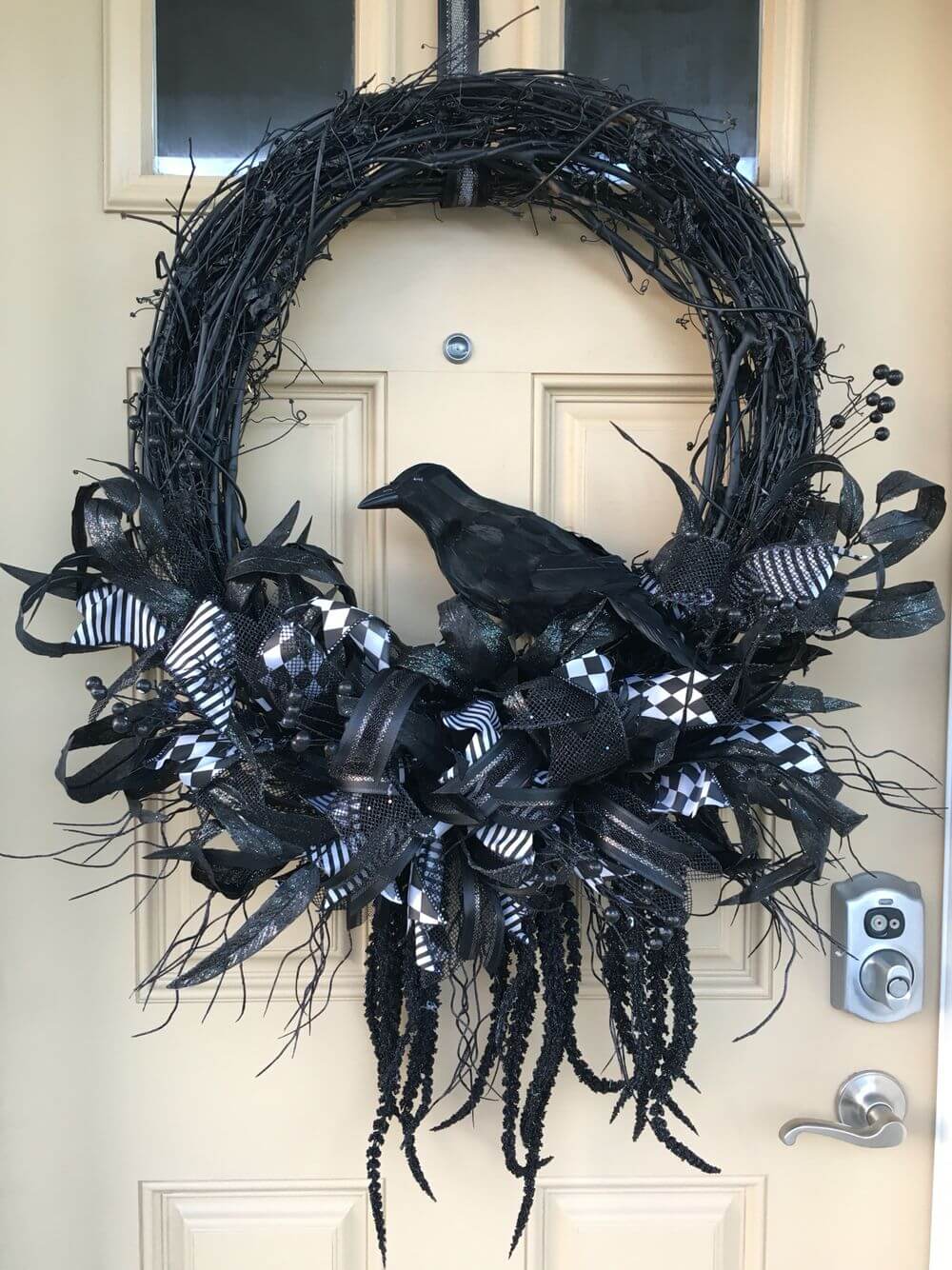 A black wreath with a bird on it
