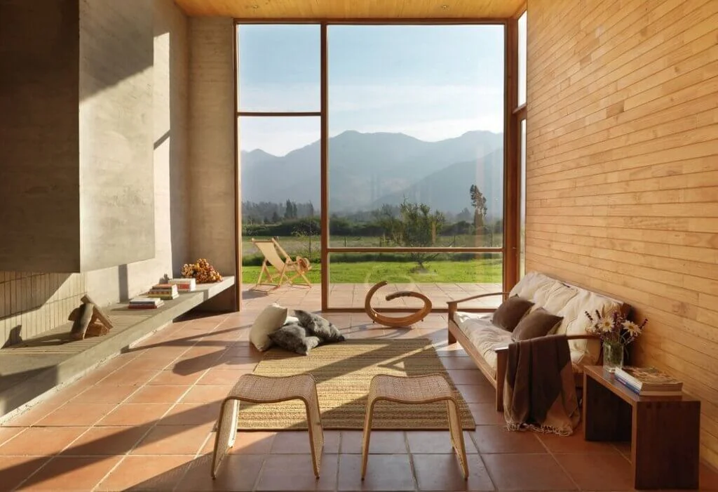 A living room with a wooden floor and a view of the mountains.