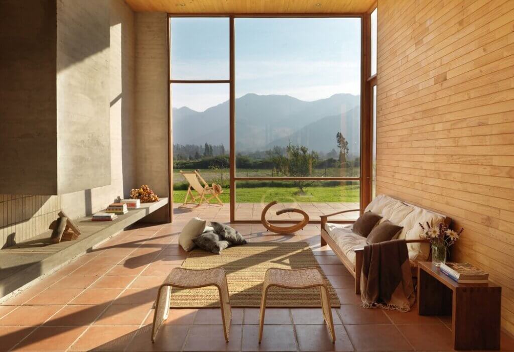 A living room with a wooden floor and a view of the mountains.