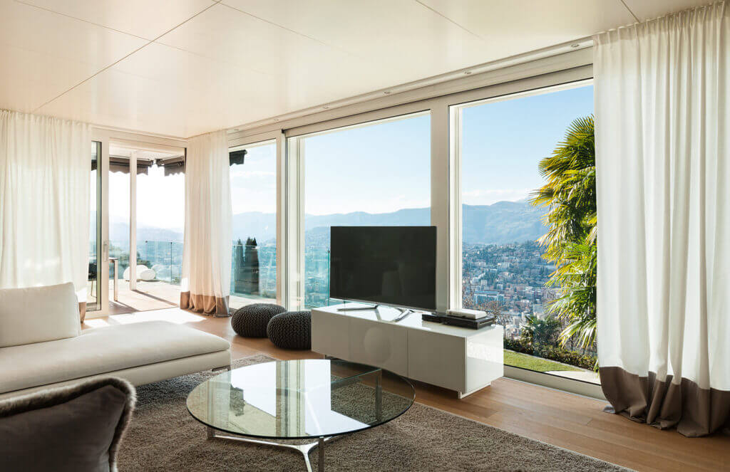 A living room with large windows overlooking the mountains.
